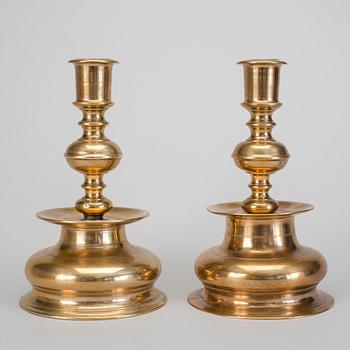 A set of two 18th century baroque brass candle sticks.