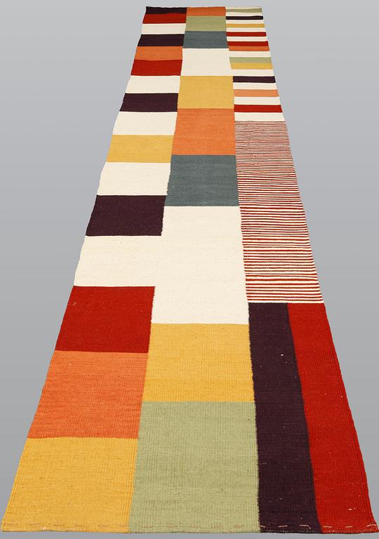An oriental flat weave carpet, c 488 x 83 cm.