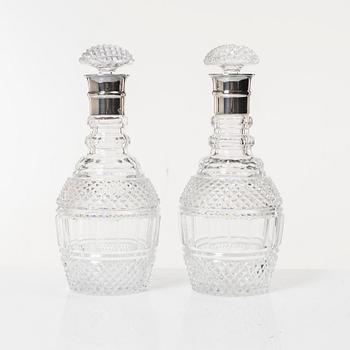 Decanters with stoppers, a pair, glass, England/Ireland 19th century with later silver mounting.