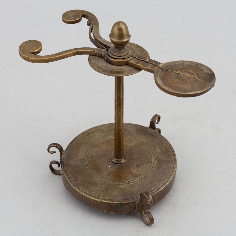 A 18th Century brass candle holder.