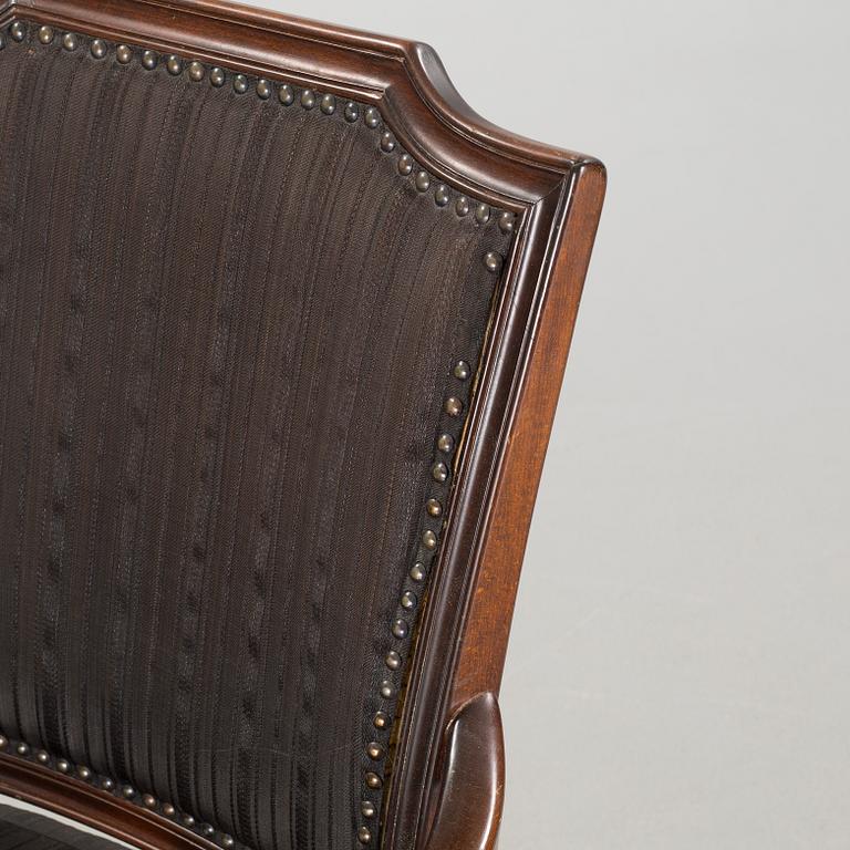 An english style dining table and eight chairs, second half of the 20th century.