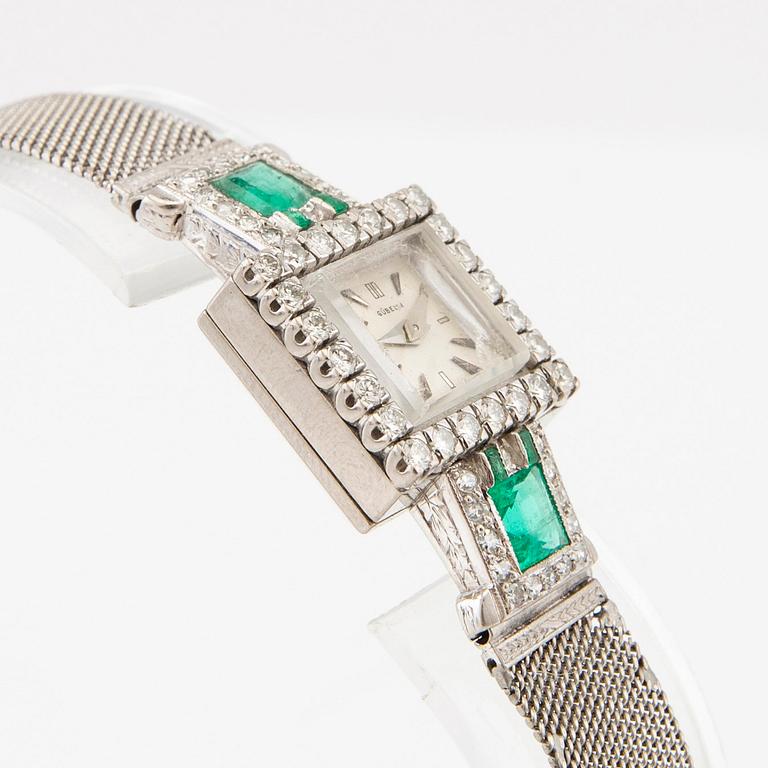 Gübelin bracelet watch in 950 platinum with round brilliant-cut and single-cut diamonds as well as step-cut emeralds.