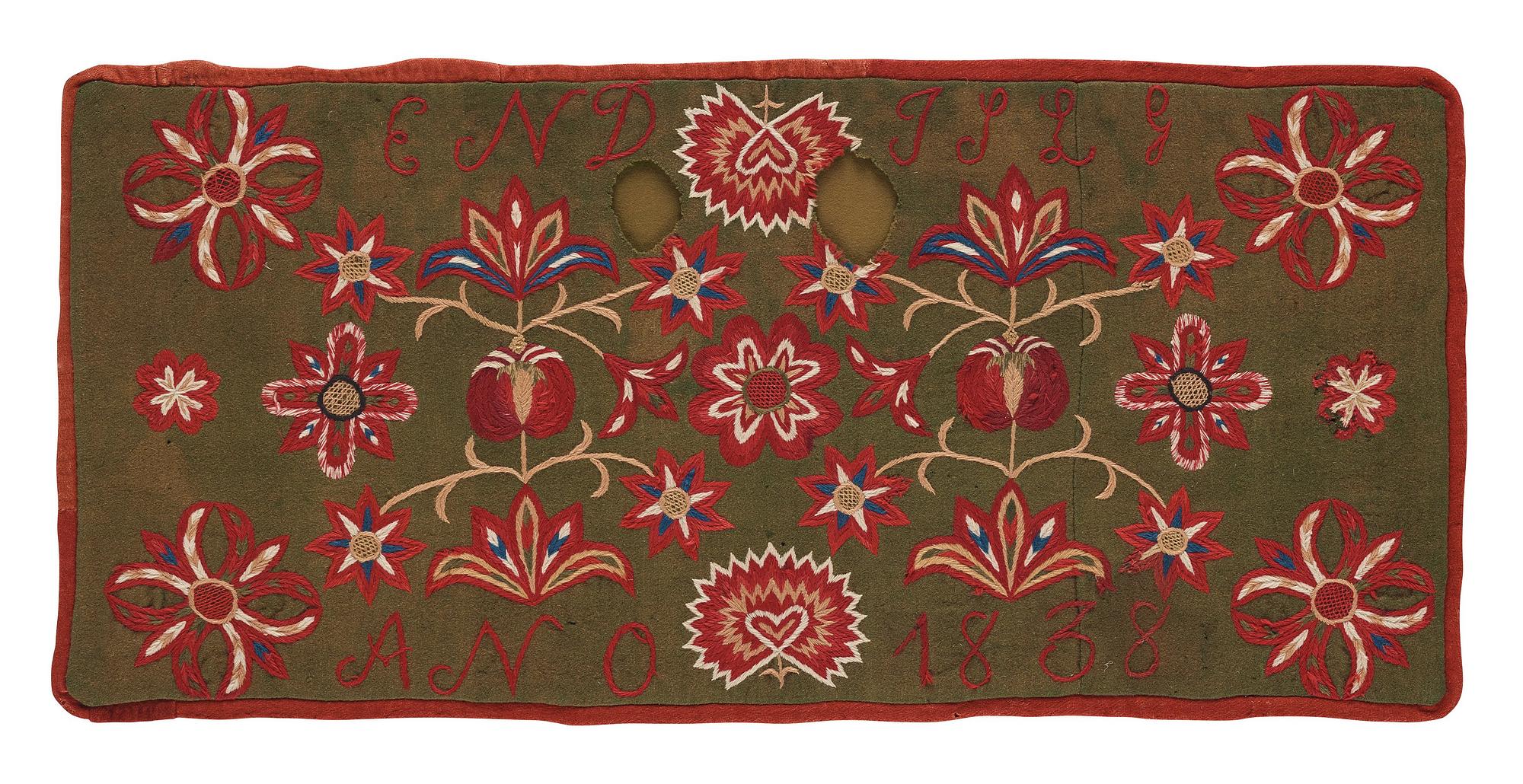 An embroidered carriage cushion, ca 51 x 113 cm (with mounting 61 x 122 cm) signed and dated END JPLG ANO 1838, Scania.