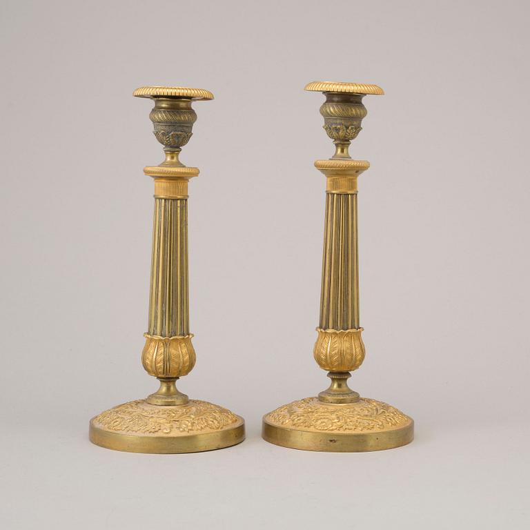 A pair of early 19th century ormolu candlesticks.