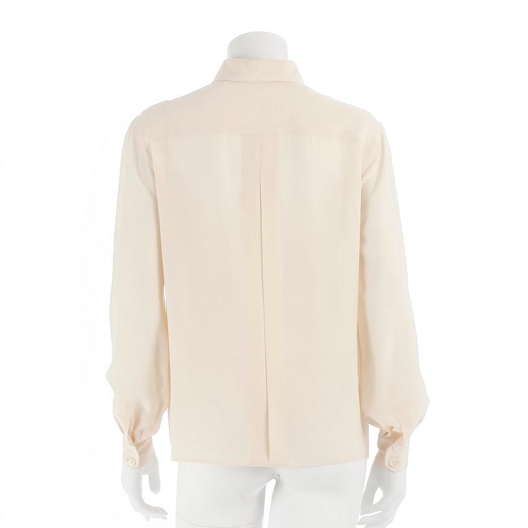 CÉLINE, a créme colored silk blouse.