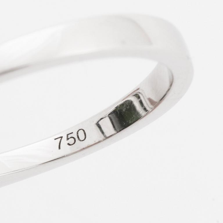 An 18K white gold ring set with a step-cut green tourmaline and round brilliant-cut diamonds.