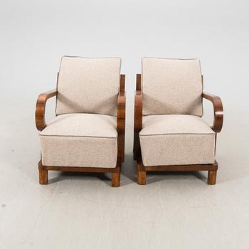 A pair of walnut Art Deco armchairs.