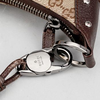 GUCCI, a beige monogram canvas shoulderhandbag.