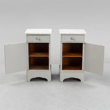 A pair of marble top bedside tables, first half of the 20th Century.