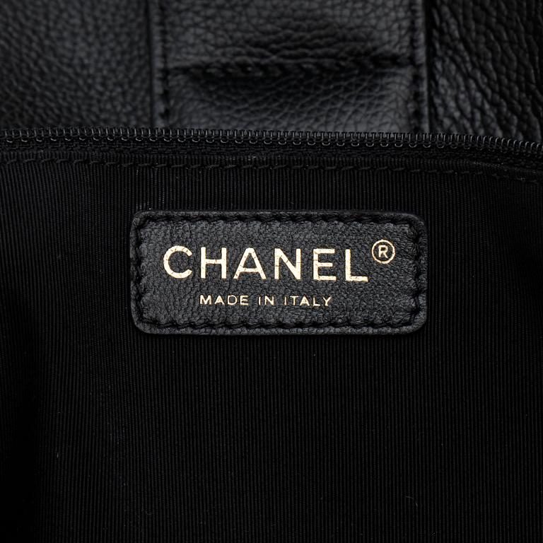CHANEL,  a black leather bag.