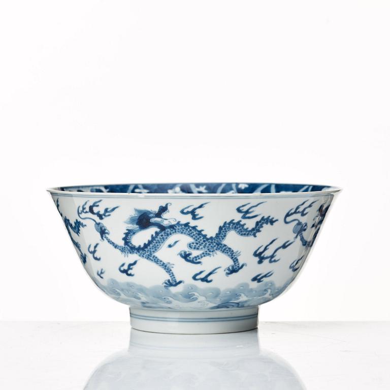 A blue and white four clawed dragon bowl, Qing dynasty, with Kangxis six character mark and period.