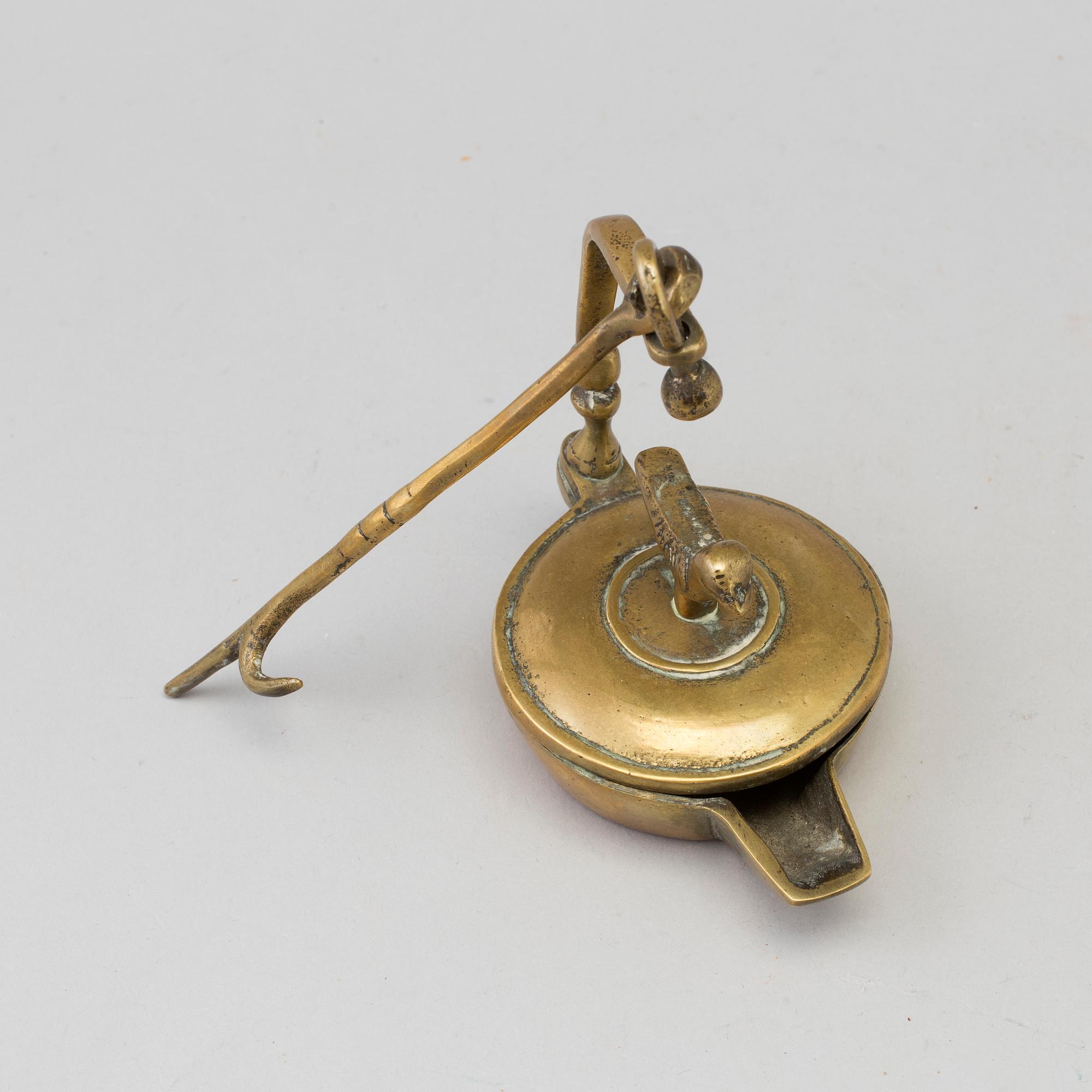 An 18th century bronze oil lamp.