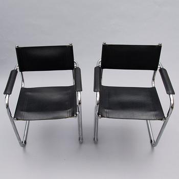 A Set of Three Chrome and Black Leather Chairs.