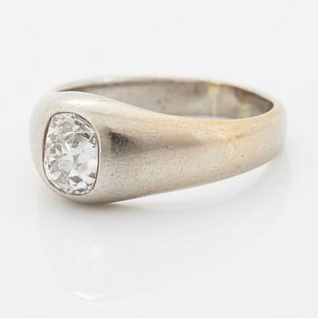 A platinum ring set with a cushion shaped old-cut diamond.