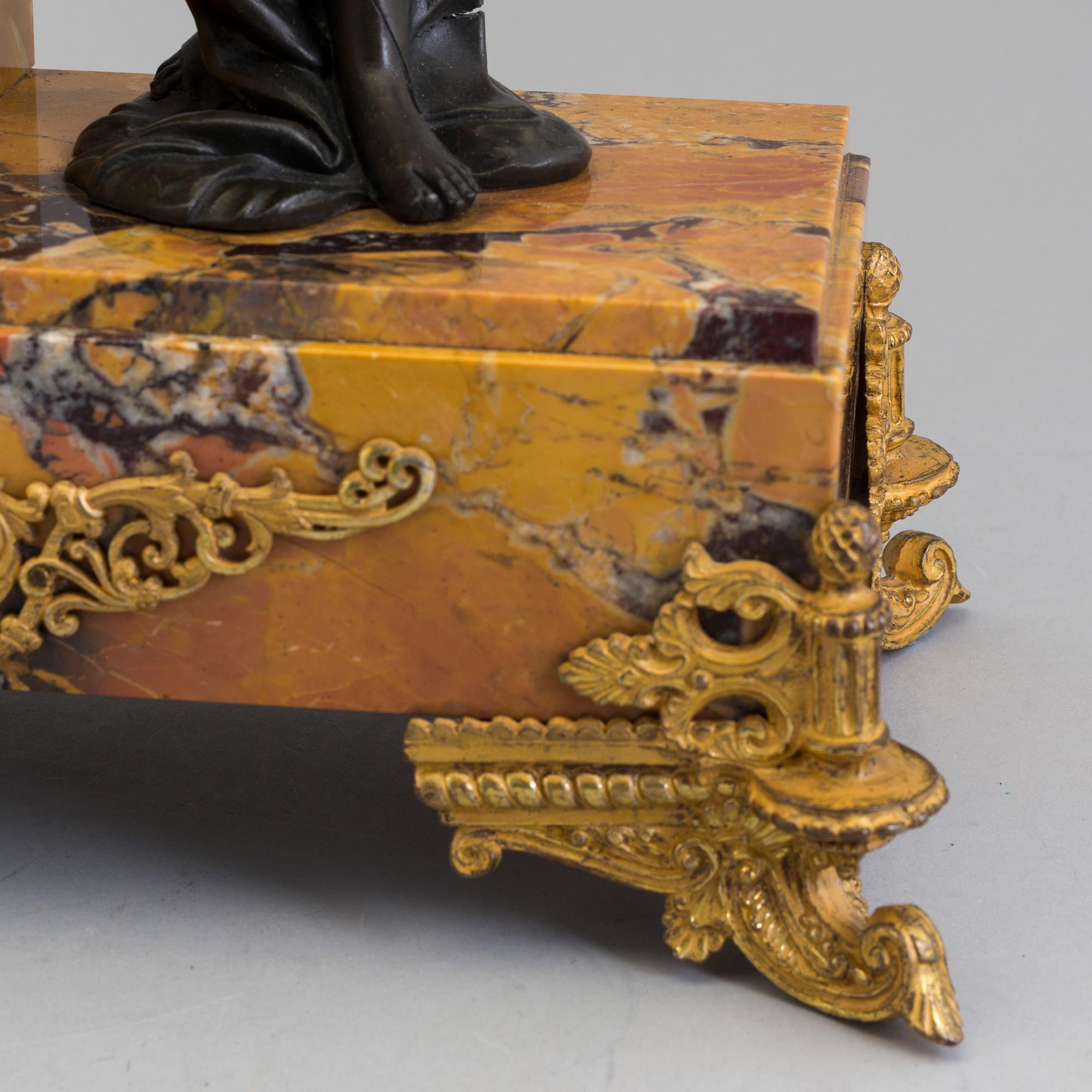 A turn of the century 1900 gilt brass and marble century mantle clock.