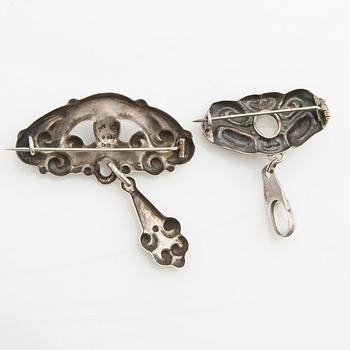 Brooches, 2 pieces, Art Nouveau, early 20th century, pewter, moonstone, and green stone.