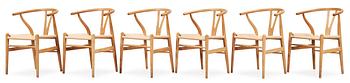 59. A set of six Hans J Wegner oak 'Wishbone chairs', Carl Hansen & Søn, Denmark.