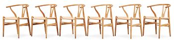 A set of six Hans J Wegner oak 'Wishbone chairs', Carl Hansen & Søn, Denmark.