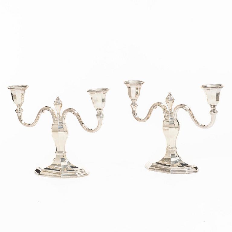 A pair of silver candelabras, with Swedish import marks, possibly mid20th century.