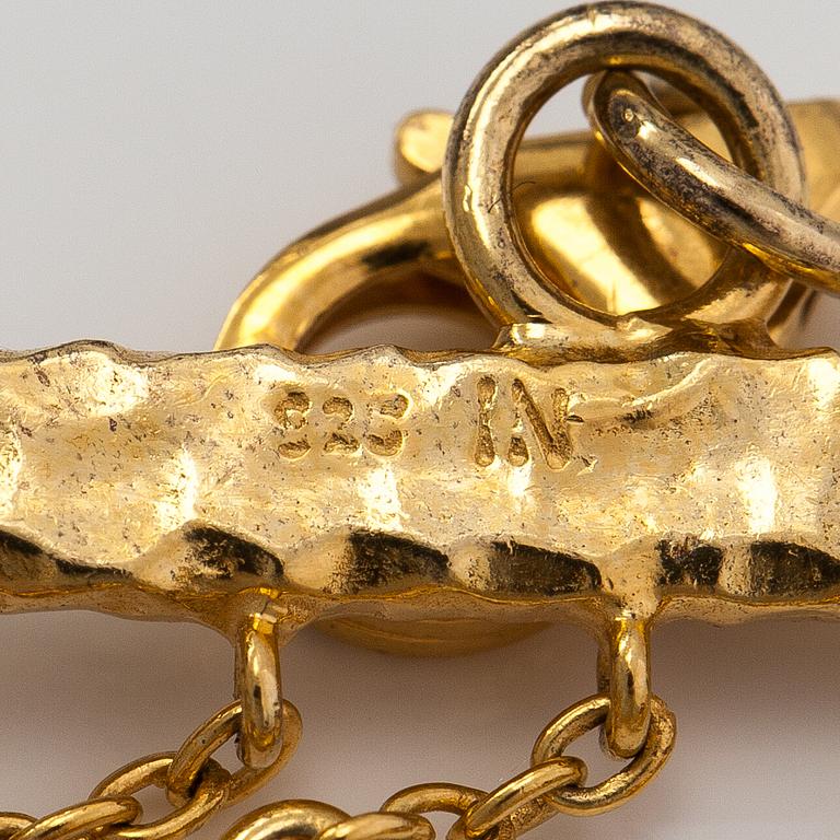 A gilded silver bracelet with topazes, garnets, peridotes, amethysts and quartzes.