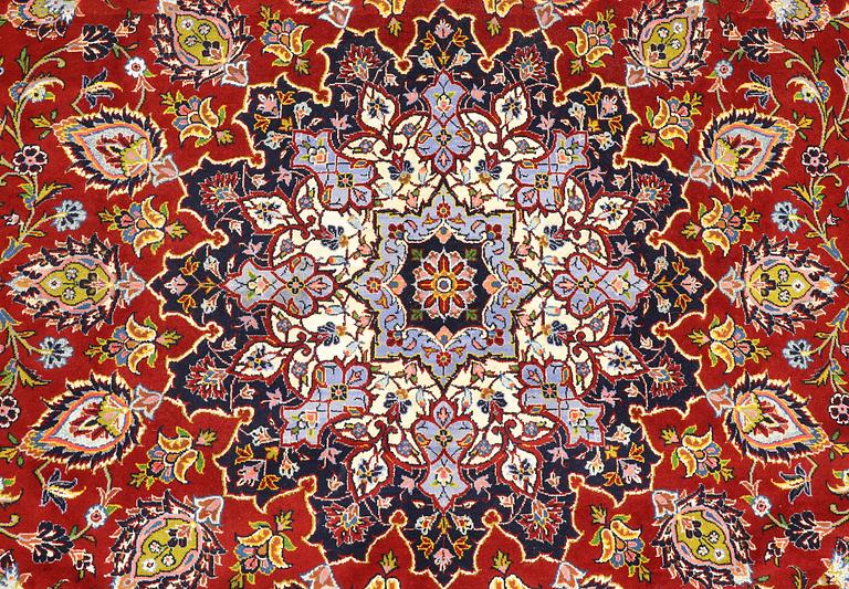 A Keshan carpet, part silk, signed, approx. 398 x 270 cm.