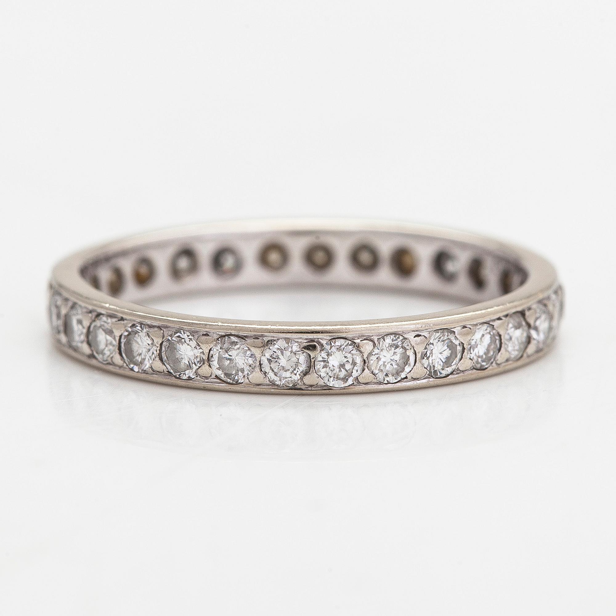 An 18K white gold eternity ring with brilliant-cut diamonds totalling approximately 0.60 ct.