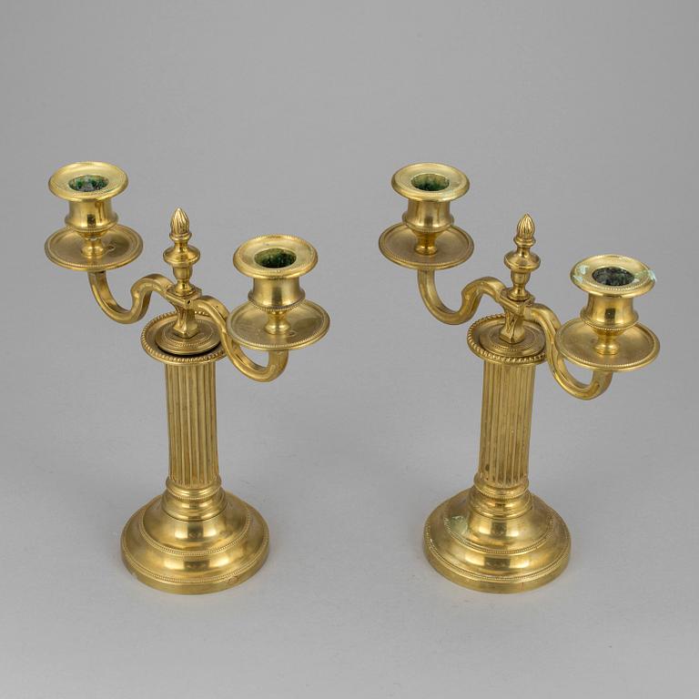 A pair of french 18th century brass candelabras.