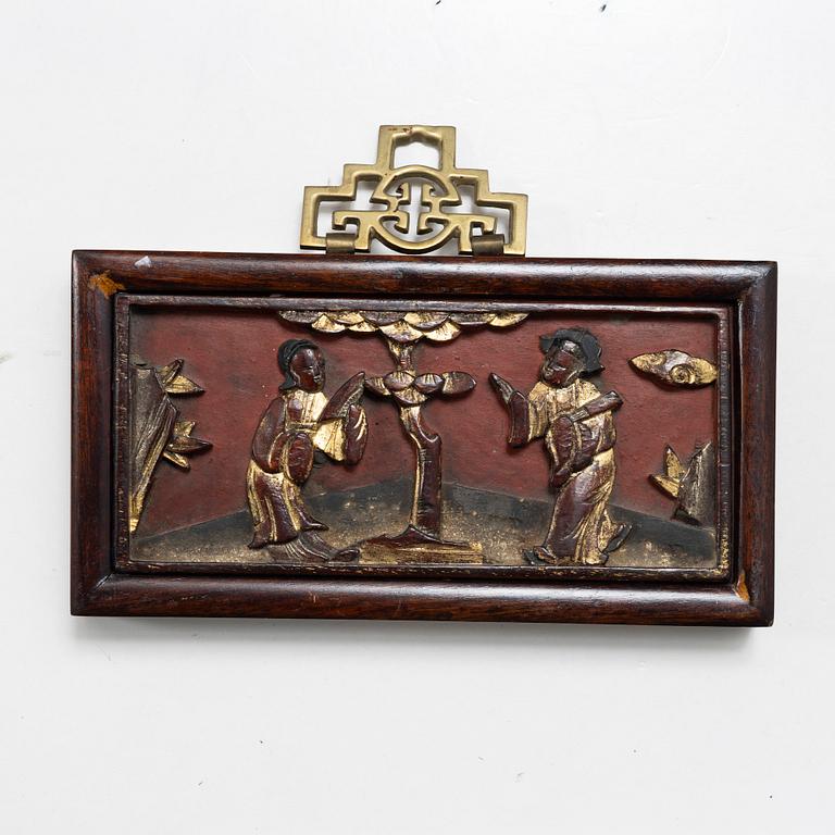 Three Chinese lacquer and wooden panels, two silk embroideries, first half of the 20th century.