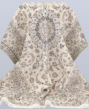 A Nain, part silk carpet, 305 x 207 cm.