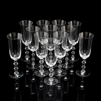 A set of twelve champagne glasses by Simon Gate.