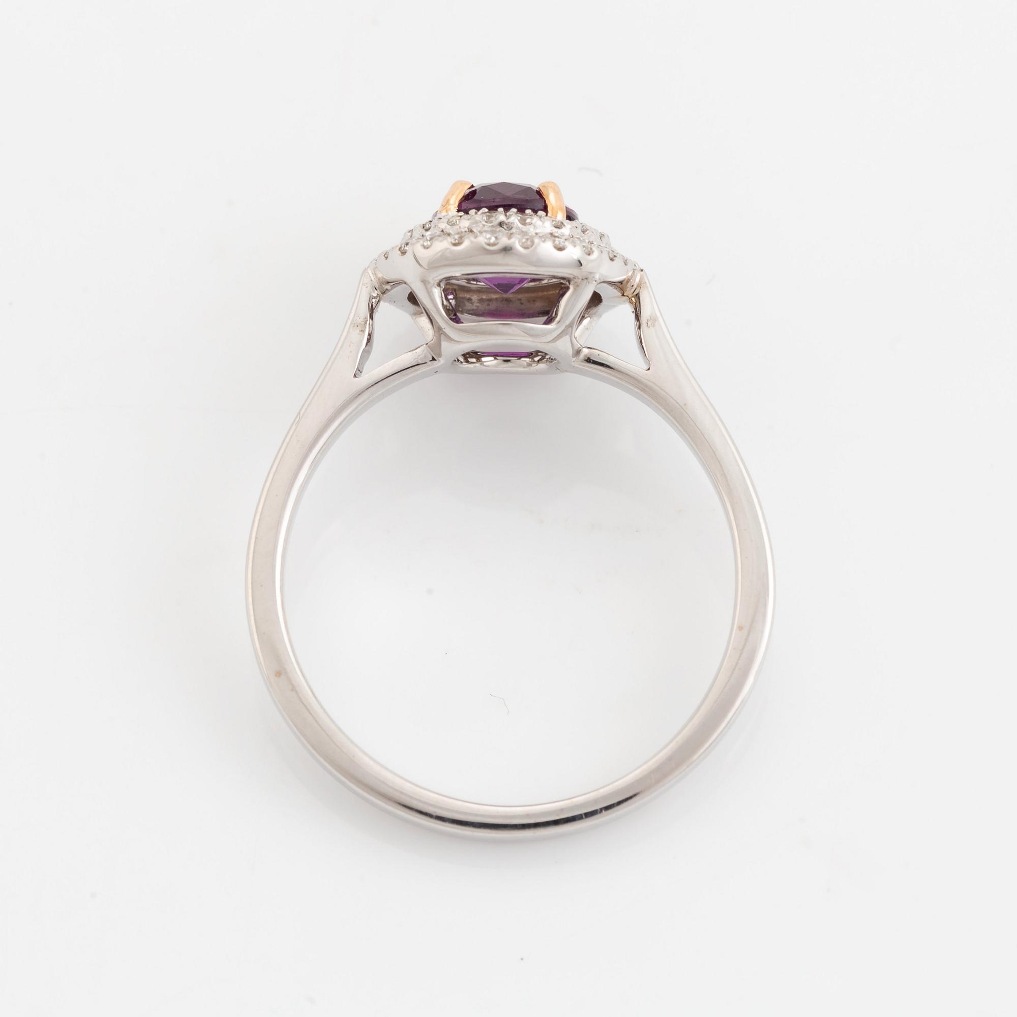 An 18K white gold ring set with a faceted ruby.