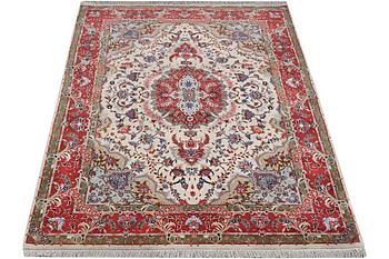A Tabriz carpet, part silk, 50 raj, c. 204 x 154 cm.