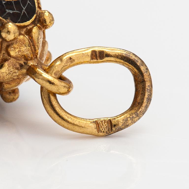 A gilded brass pendant with enamel and glass stones.