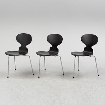 An Arne Jacobsen "Centenary Package" comprising three "Ant Chairs" and an eggshaped table, Fritz Hansen, Denmark.