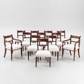 A set of 10 mahogany chairs and 2 armchairs, Regency style, from around the year 1900.