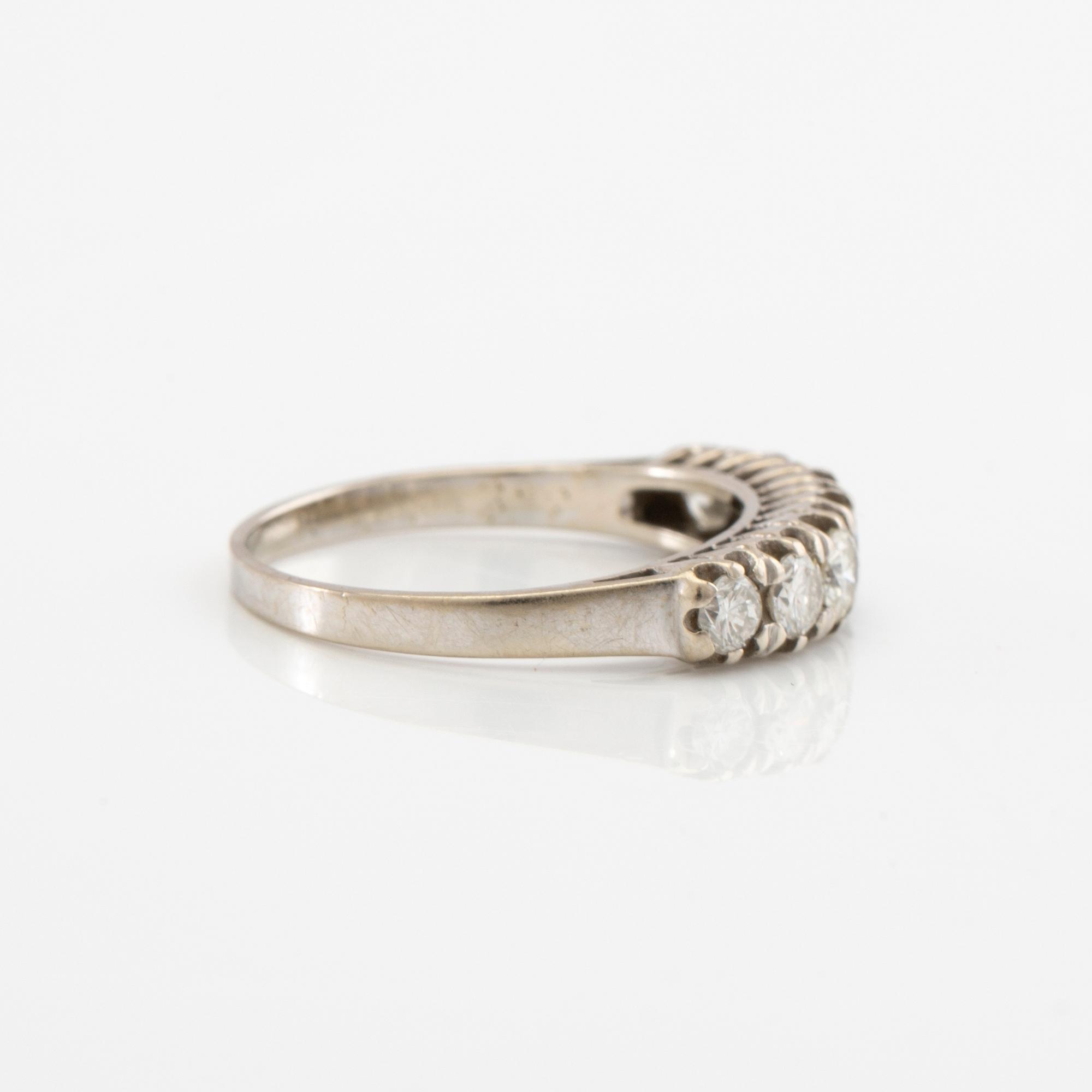 Half-eternity ring in 18K white gold set with round brilliant-cut diamonds, approximately 0.93 ct in total.