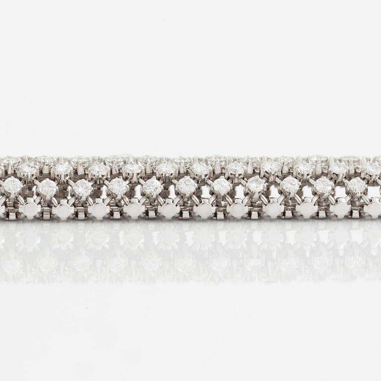 A platinum bracelet set with round brilliant-cut diamonds.