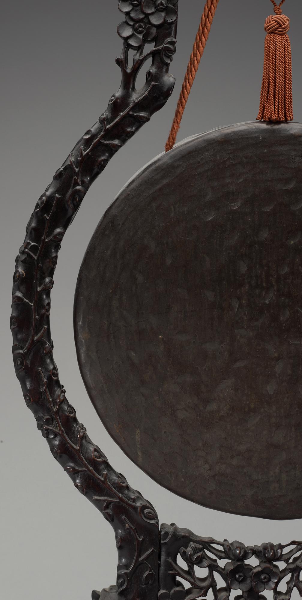 A bronze gong with a wooden stand, Qing dynasty.