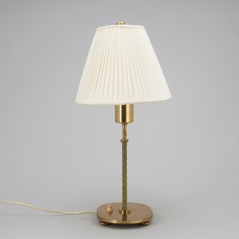 A Josef Frank brass and green leather table lamp by Svenskt Tenn.