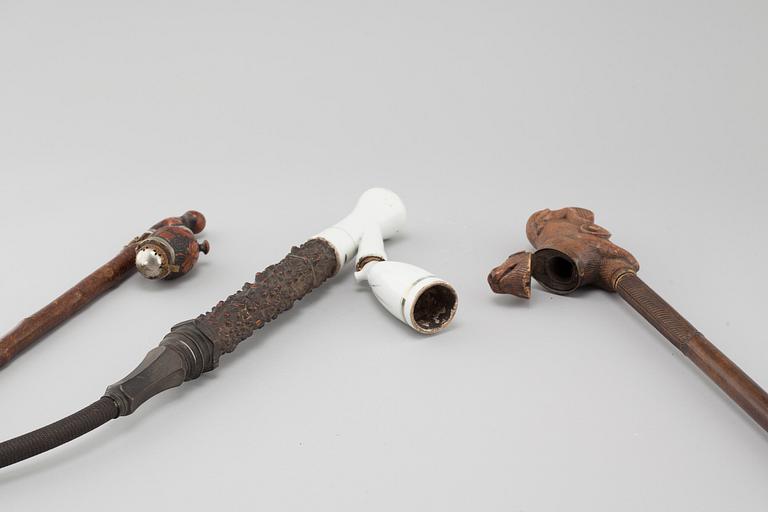 Three mainly 19th century pipes, one dated 1711.