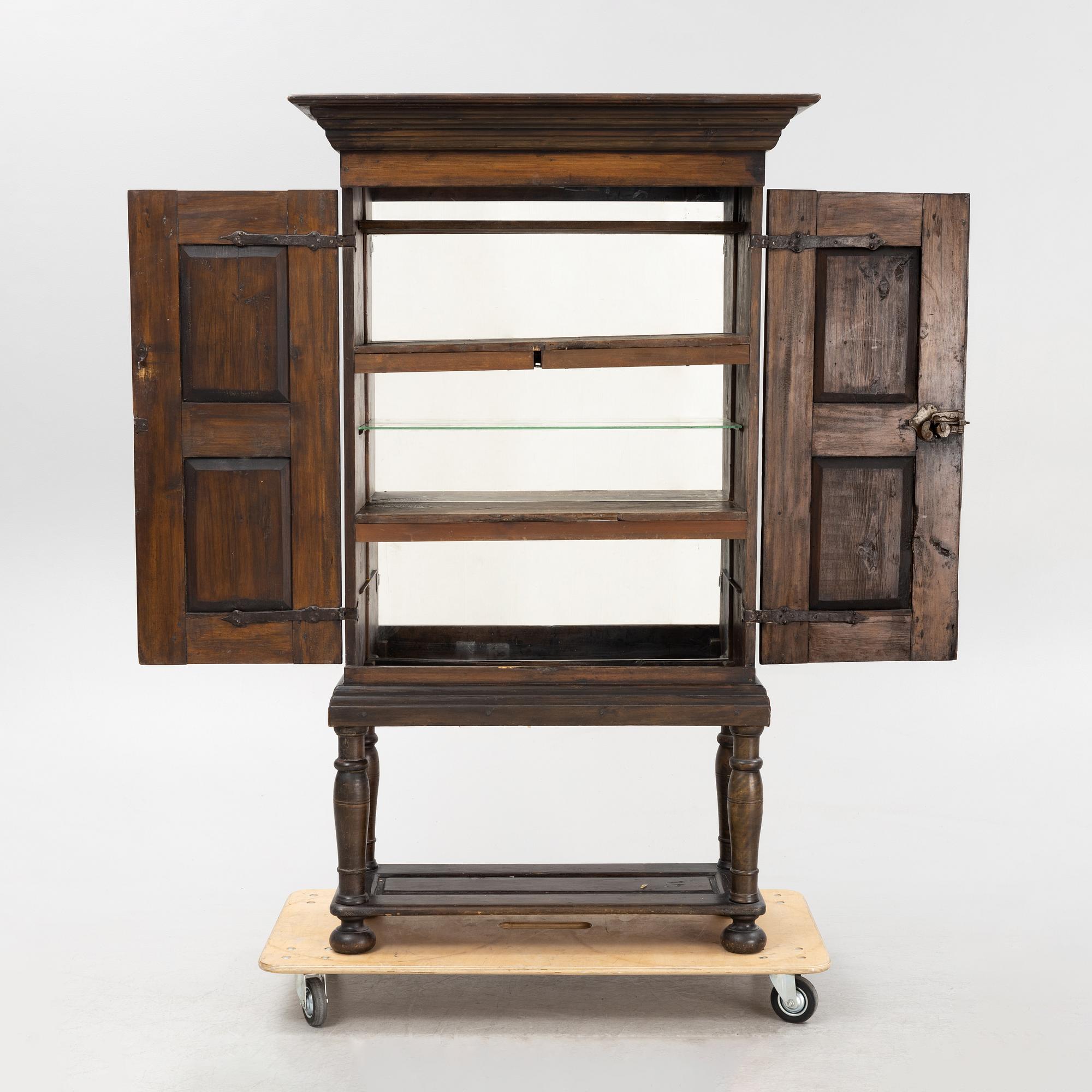 A Baroque style cabinet on later stand, first part of the 18th Century.