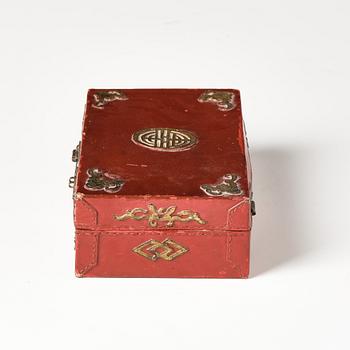 A set of two gilt decorated leather clad wooden chests, late Qing dynasty.