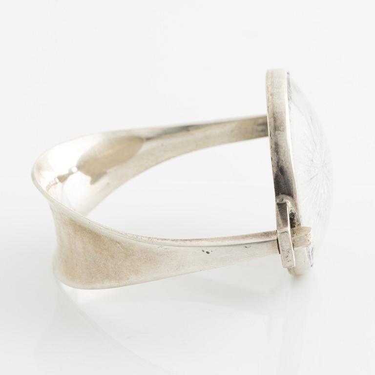 Bangle, silver with inset stone/flower.