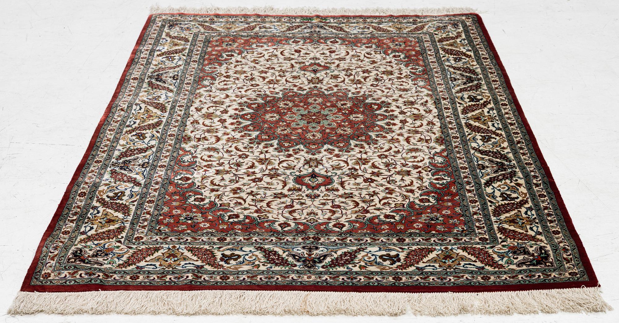A Ghom silk rug, signed, c. 148 x 100 cm.