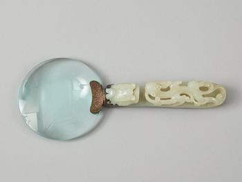 A Chinese archaistic nephrite belt hook, mounted as a magnifying glass.