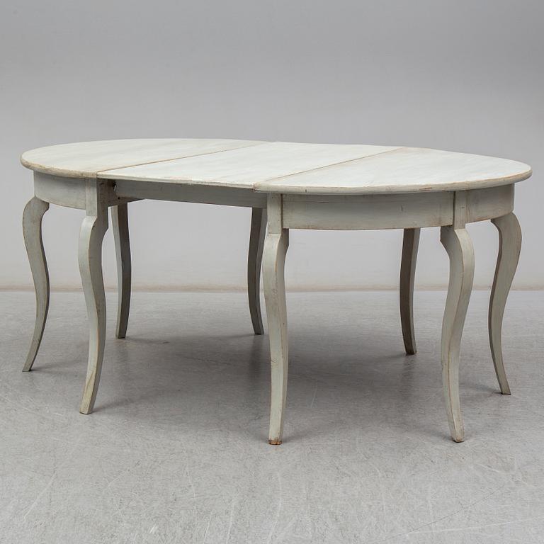 a two-part dining table from the mid 19th century.