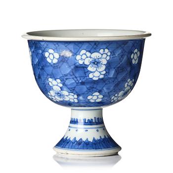 1132. A blue and white 'prunus' stem cup, Qing dynasty, Kangxi (1662-1722).