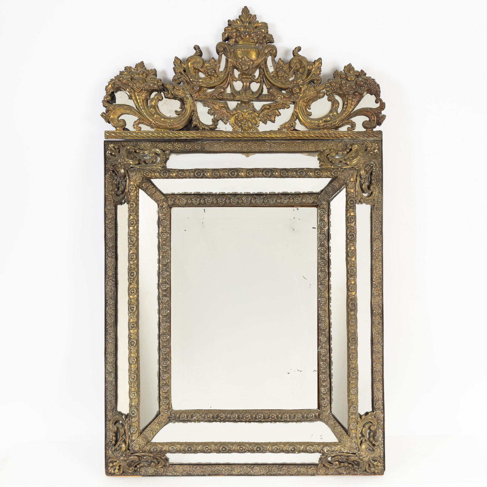 A Baroque style repoussé mirror, circa 1900.