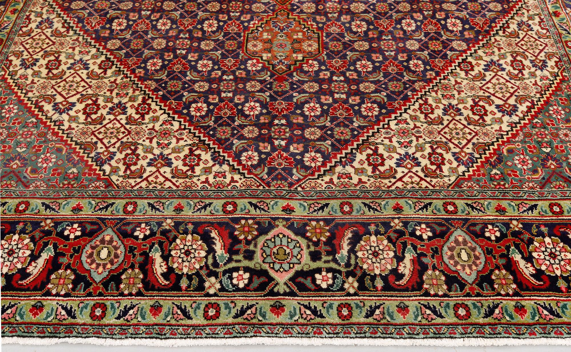 A Tabriz carpet, approximately 360 x 255 cm.