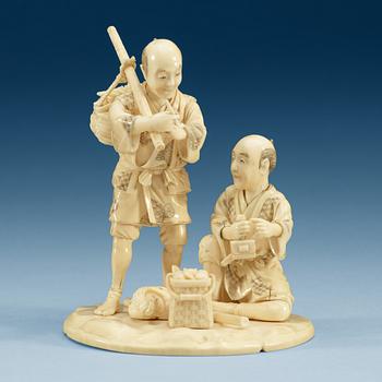 1889. A Japanese ivory sculpture of two men, period of Meiji (1868-1912). Signed.